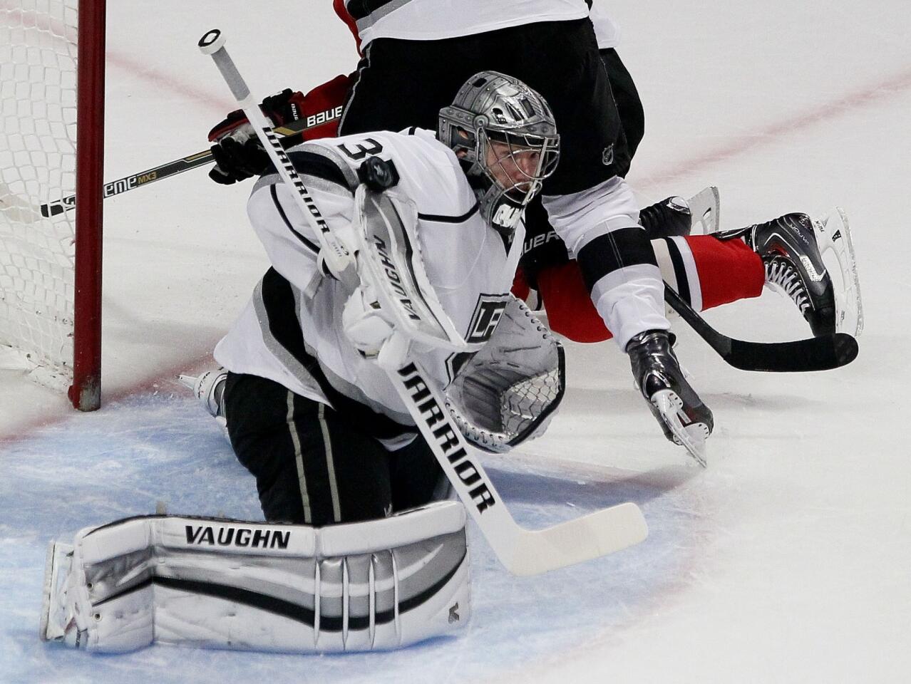 Kings goaltender Jonathan Quick blocks a shot by the Blackhawks with the pad on his right glove in the third period of Game 2 on Wednesday night in Chicago.