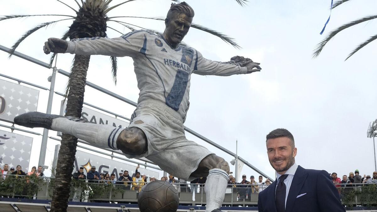 David Beckham poses with the newly unveiled statue — the real one — in front of Dignity Health Sports Park in Carson on March 2.