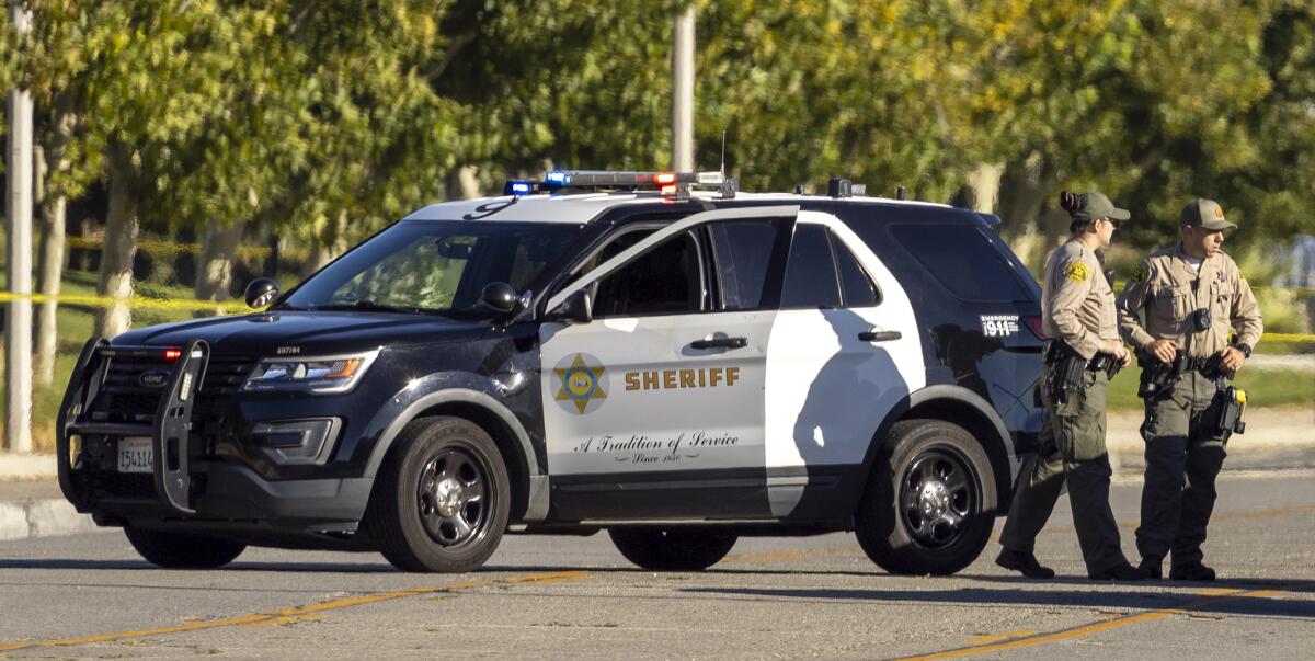 Los Angeles County sheriff's deputies secure the scene Sunday morning.