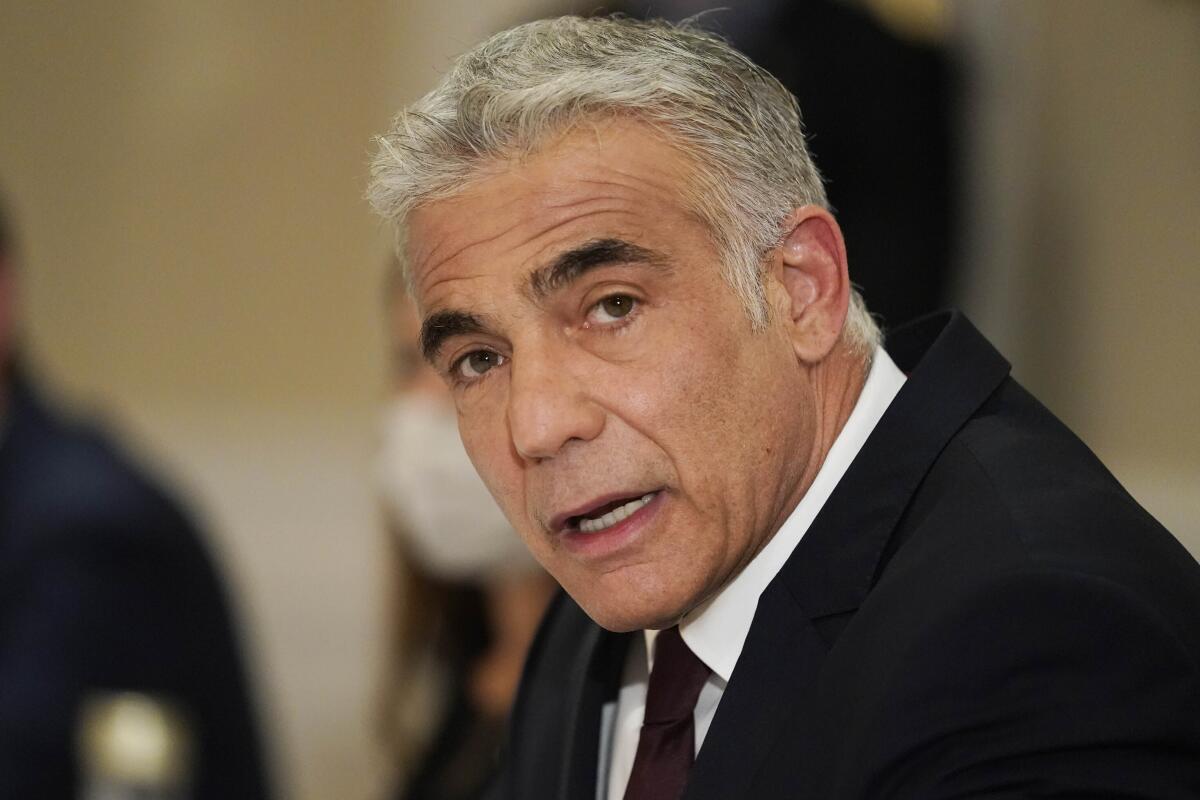 A closeup of Yair Lapid in suit and tie.