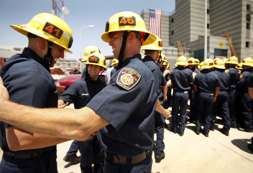 New LAFD firefighters shake hands at the recruit graduation ceremony in Panorama City on June 12.