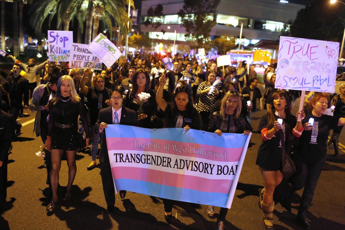 People gather outside the West Hollywood Public Library  to honor Transgender Day of Remembrance.