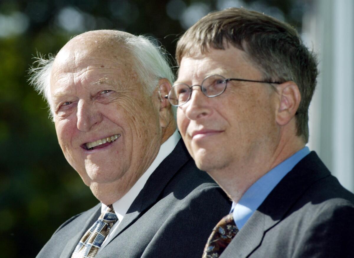 William H. Gates Sr., left, with his son, Bill Gates Jr., during the dedication of the William H. Gates Hall on 2003.