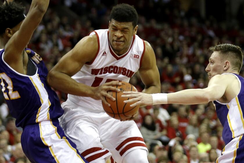 Wisconsin's Charlie Thomas tries to muscle his way past two Western Illinois defenders Friday night.