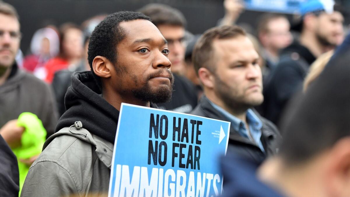 Rovante Robinson holds up a sign as protesters rally outside a hotel where Attorney General Jeff Sessions speaks in Sacramento on March 7.