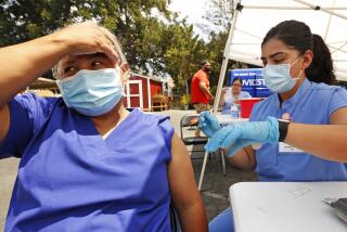 LOS ANGELES, CA - JULY 23: Auxiliadora Gutierrez, 50, gets the Covid vaccine from Registered Nurse Jonica Portillo at the Pico Union Project located at 1153 Valencia where Curative is offering Covid testing and a choice of Pfizer or Johnson and Johnson Covid vaccine on Friday morning. We're asking the few that attended what has finally motivated people to get vaccinated. Pico Union Project on Friday, July 23, 2021 in Los Angeles, CA. (Al Seib / Los Angeles Times).