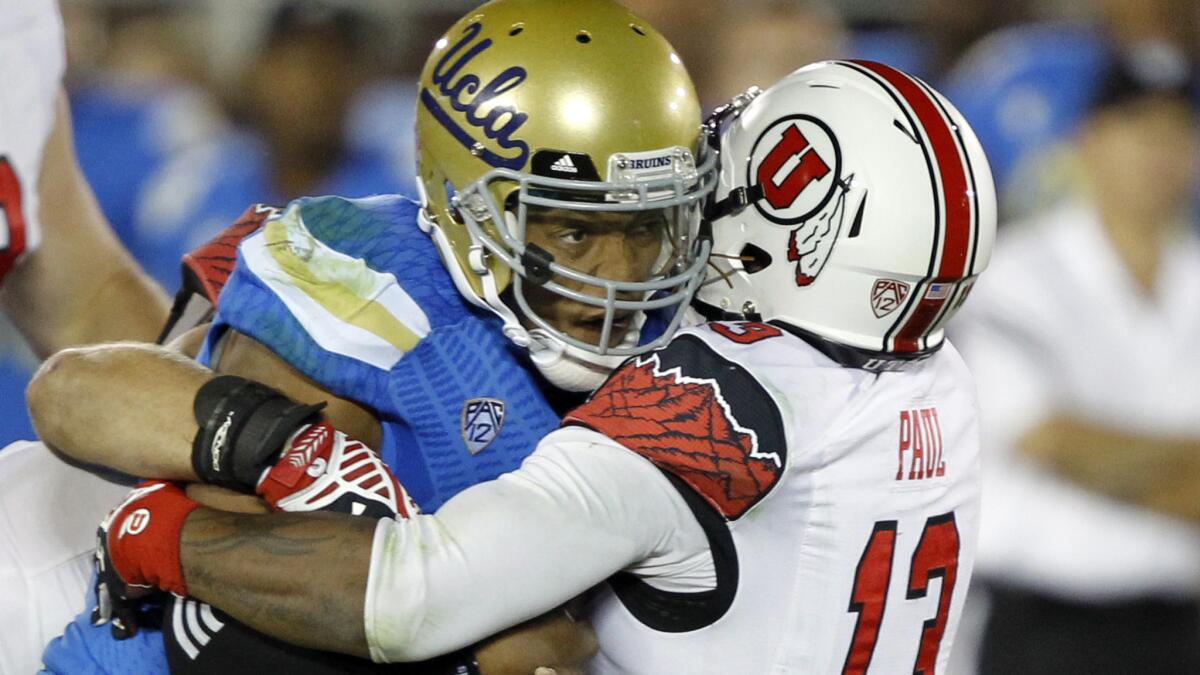 Utah linebacker Gionni Paul tackles UCLA quarterback Brett Hundley at the line of scrimmage during the second half of the Bruins' loss Saturday.