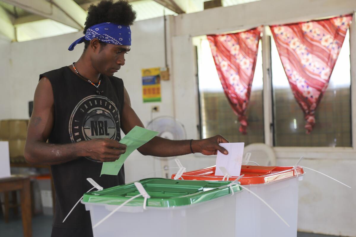 A man casts his vote during the Solomon Islands elections.