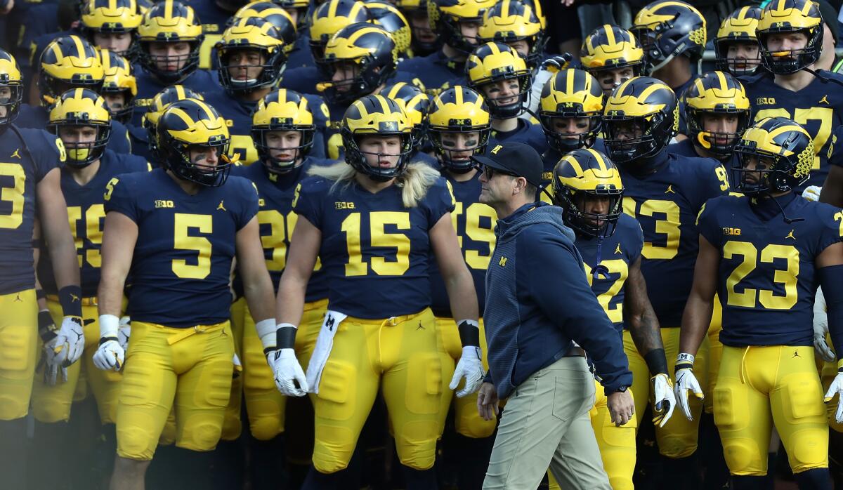 Michigan coach Jim Harbaugh walks in front of his players before a game against Penn State in November.