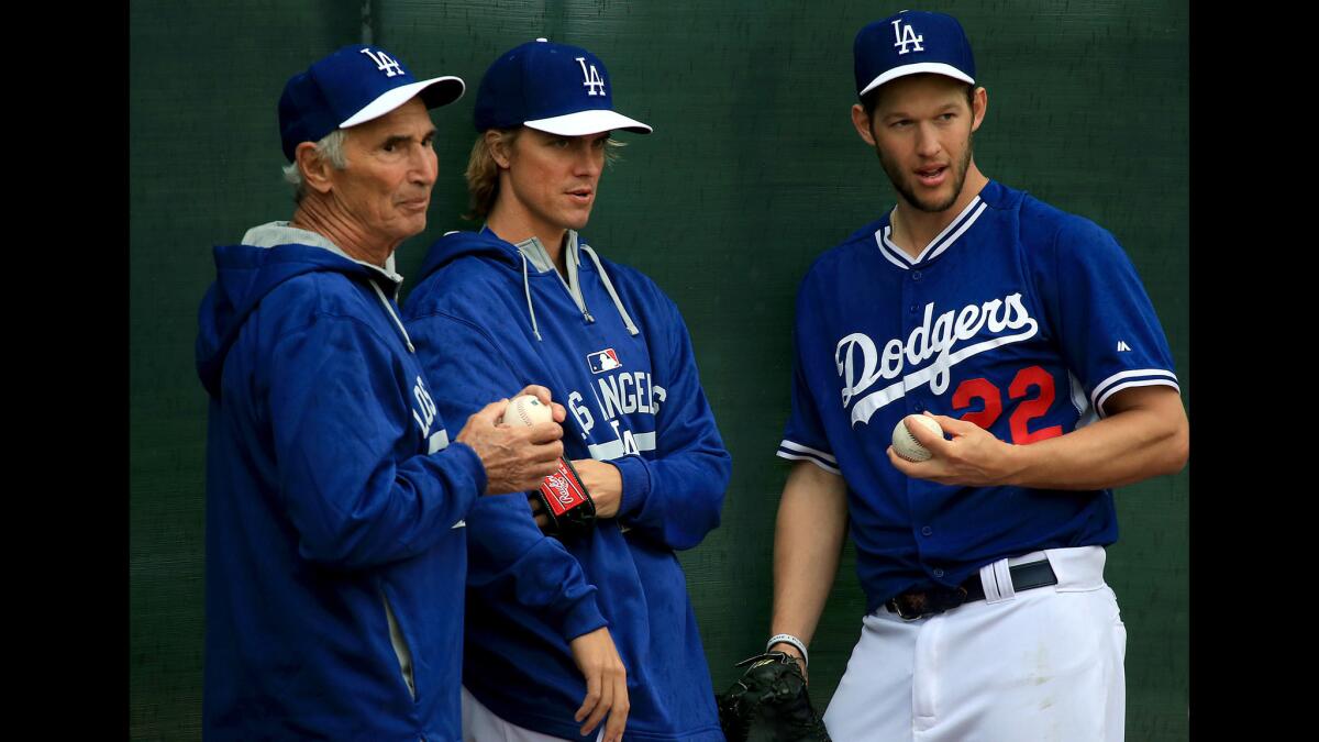 Hall of Fame pitcher Sandy Koufax, left, talks with Dodgers starters Zack Greinke, center, and Clayton Kershaw at spring training on March 2.