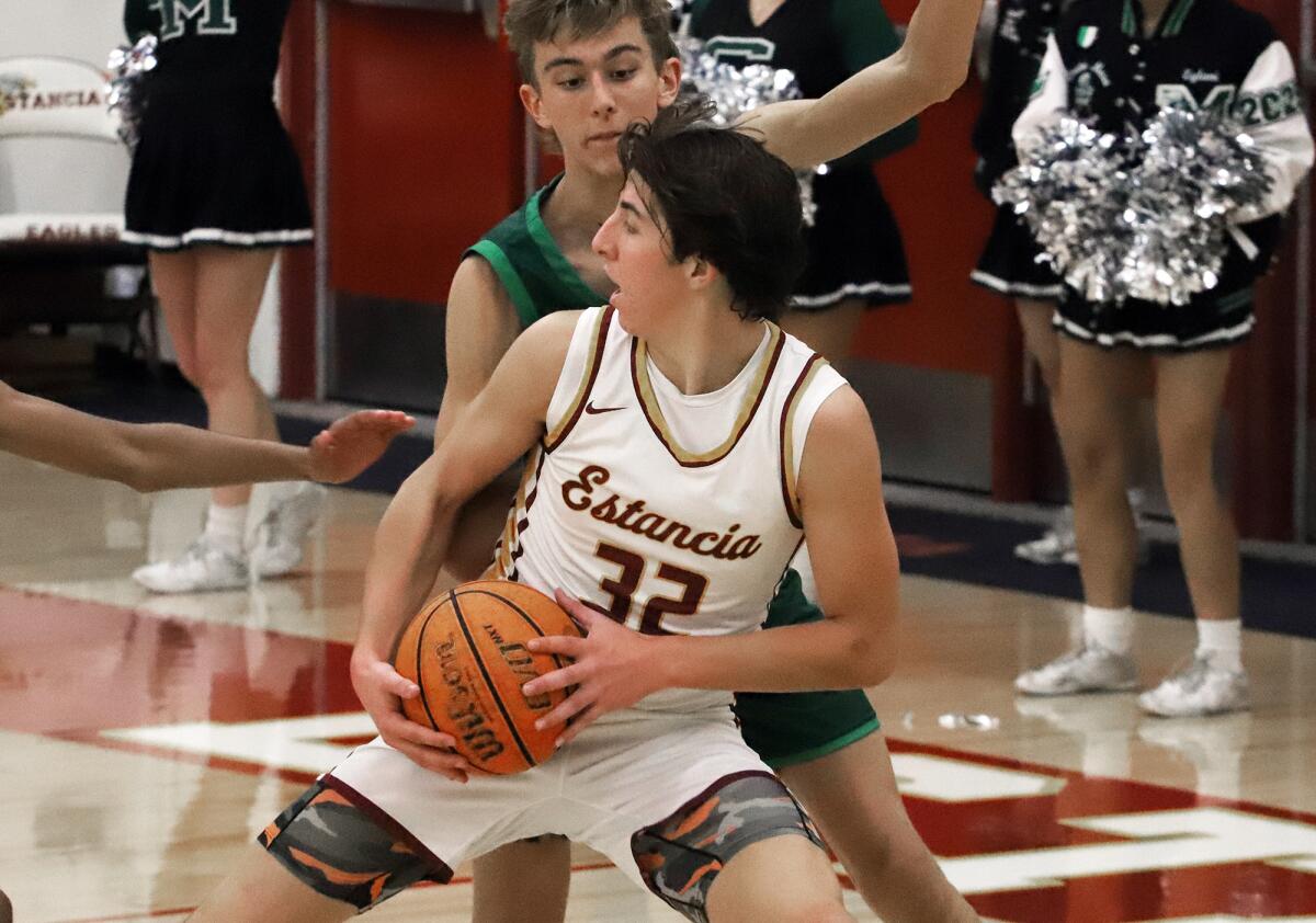 Estancia's Miles Dodge (32) posts up during Friday night's win over Costa Mesa.