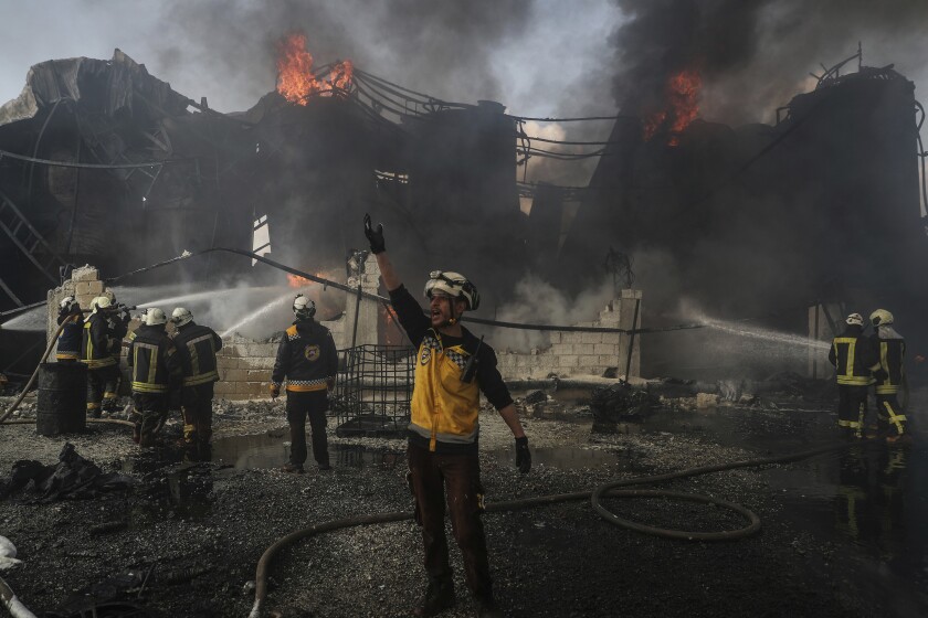 16 February 2022, Syria, Dana: Members of the Syria Civil Defence, known as White Helmets, work to extinguish a fire that broke out at a fuel depot as a result of a missile attack by the Syrian regime and Russian forces on Tarminin village near the city of Dana. According to the White Helmets, four civilians were killed and two others were injured in an artillery shelling on a fuel market allegedly affiliated to a Jihadist group. Photo by: Anas Alkharboutli/picture-alliance/dpa/AP Images