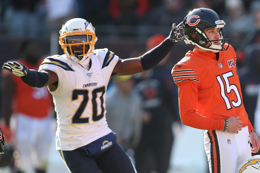 Chicago Bears kicker Eddy Pineiro (15) and Los Angeles Chargers defensive back Desmond King (20) react in different ways after Pineiro missed the game-wining kick to end the game on Sunday, Oct. 27, 2019 at Soldier Field in Chicago, Ill. (Chris Sweda/Chicago Tribune/Tribune News Service via Getty Images)