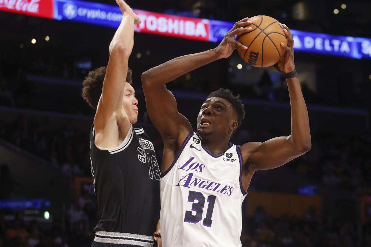 Lakers center Thomas Bryant puts up a shot over San Antonio Spurs forward Isaiah Roby during the first half on Sunday.