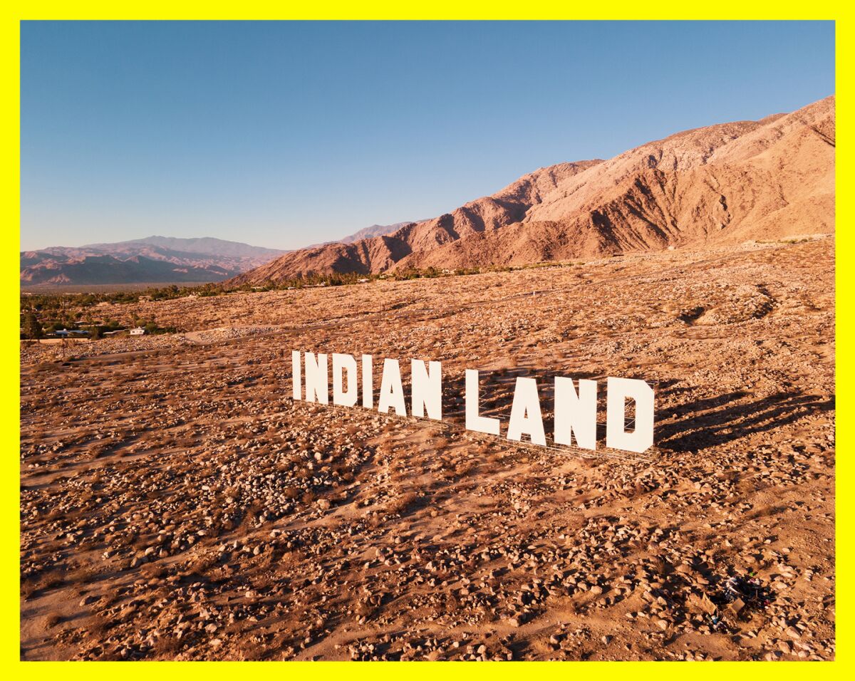 White letters sitting in a desert landscape spell out "Indian Land."