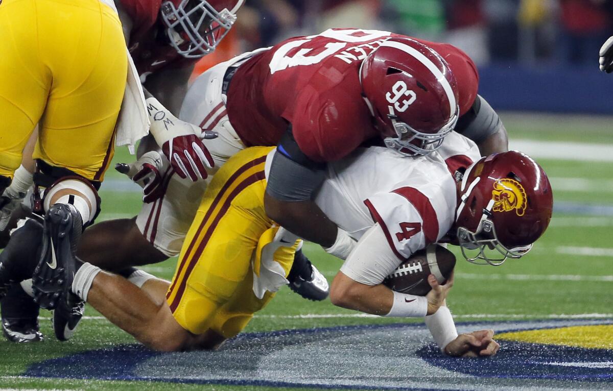 USC quarterback Max Browne (4) is sacked by Alabama defensive lineman Jonathan Allen during the first half.