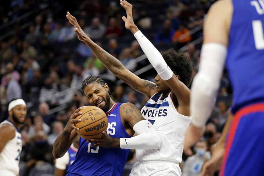 Los Angeles Clippers guard Paul George (13) drives on Minnesota Timberwolves forward Jaden McDaniels, right, during the first half of an NBA basketball game Wednesday, Nov. 3, 2021, in Minneapolis. (AP Photo/Andy Clayton-King)