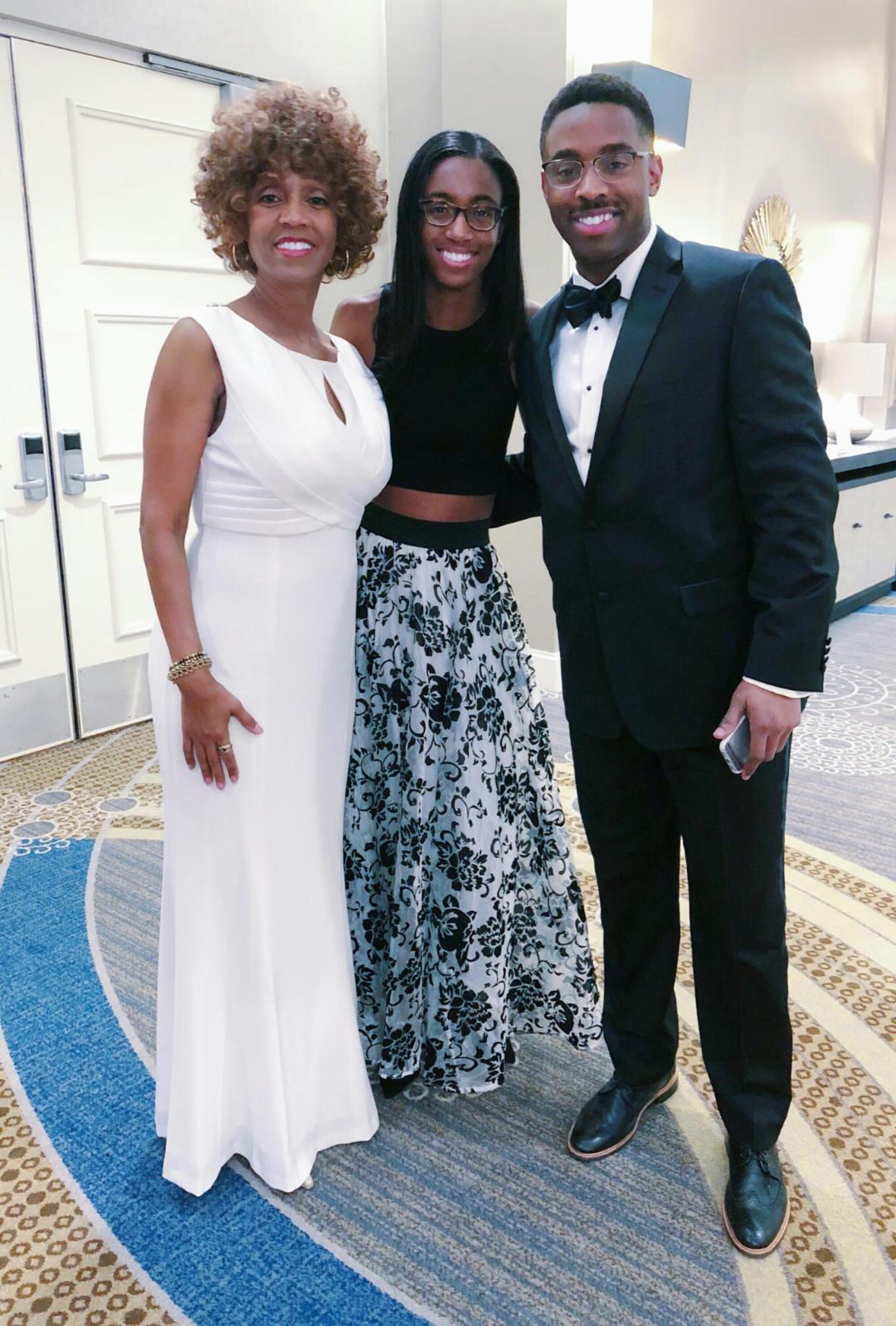 Stanley Wilson Jr., right, with his mother, Pulane Lucas, left, and sister Fredericka at a black and white gala.