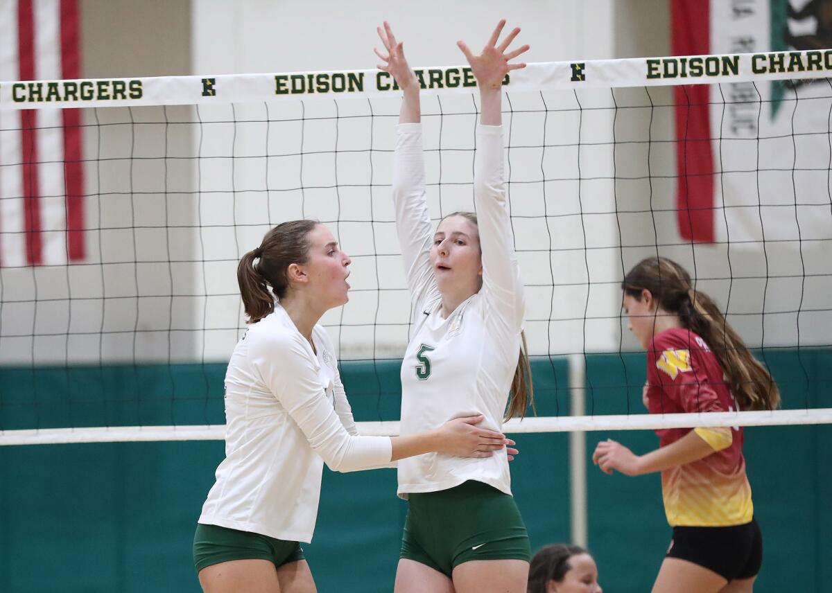Edison's Megan Fitzmorris (5) reacts to making a solid block for a point against Long Beach Wilson on Wednesday.