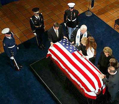 Former First Lady Nancy Reagan is comforted by her daughter Patti Davis, as her son Ron Reagan stands at the head of former President Ronald Reagan 's casket. The Rev. Michael Wenning today presided at the private service at the Ronald Reagan Presidential Library in Simi Valley.