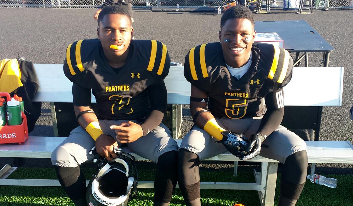 Newbury Park senior Darick Holmes Jr., left, and sophomore Darnay Holmes before making their debut on Friday night against Birmingham.