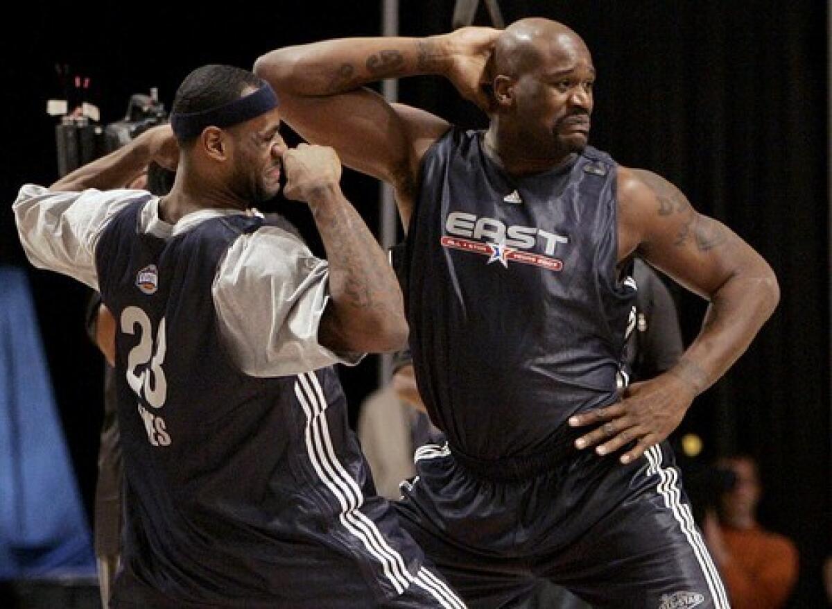 Shaquille O'Neal and LeBron James dance together during NBA All-Star basketball practice in 2007. O'Neal retired from basketball in 2011.