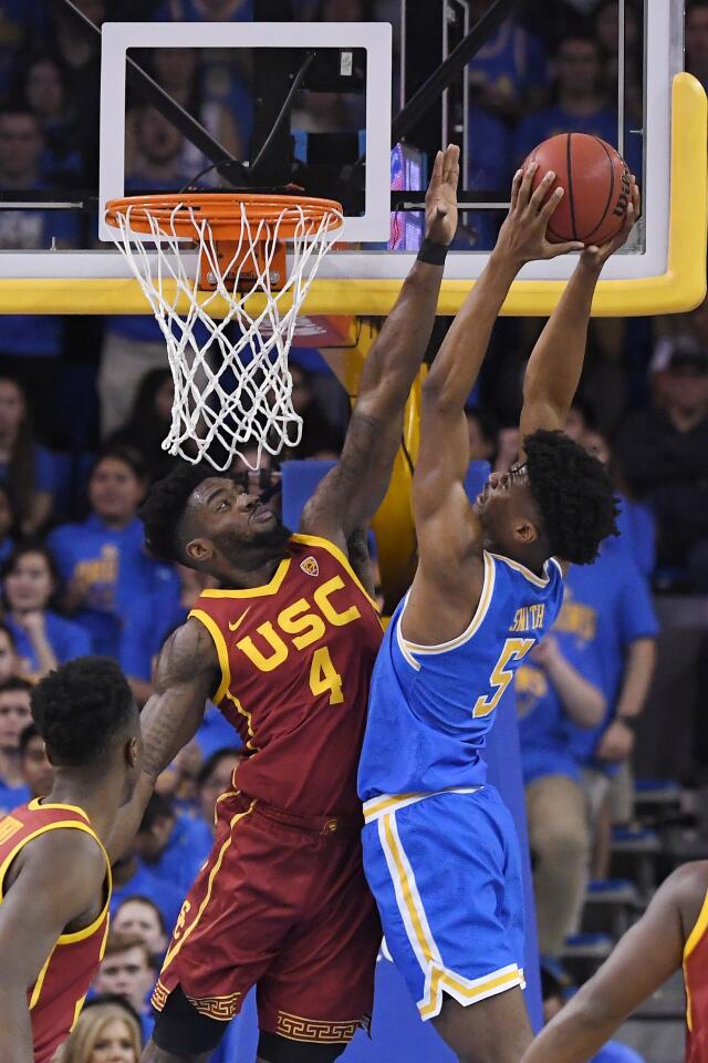UCLA guard Chris Smith goes up for a shot against USC guard Daniel Utomi during the first half of a game Jan. 11 at Pauley Pavilion.