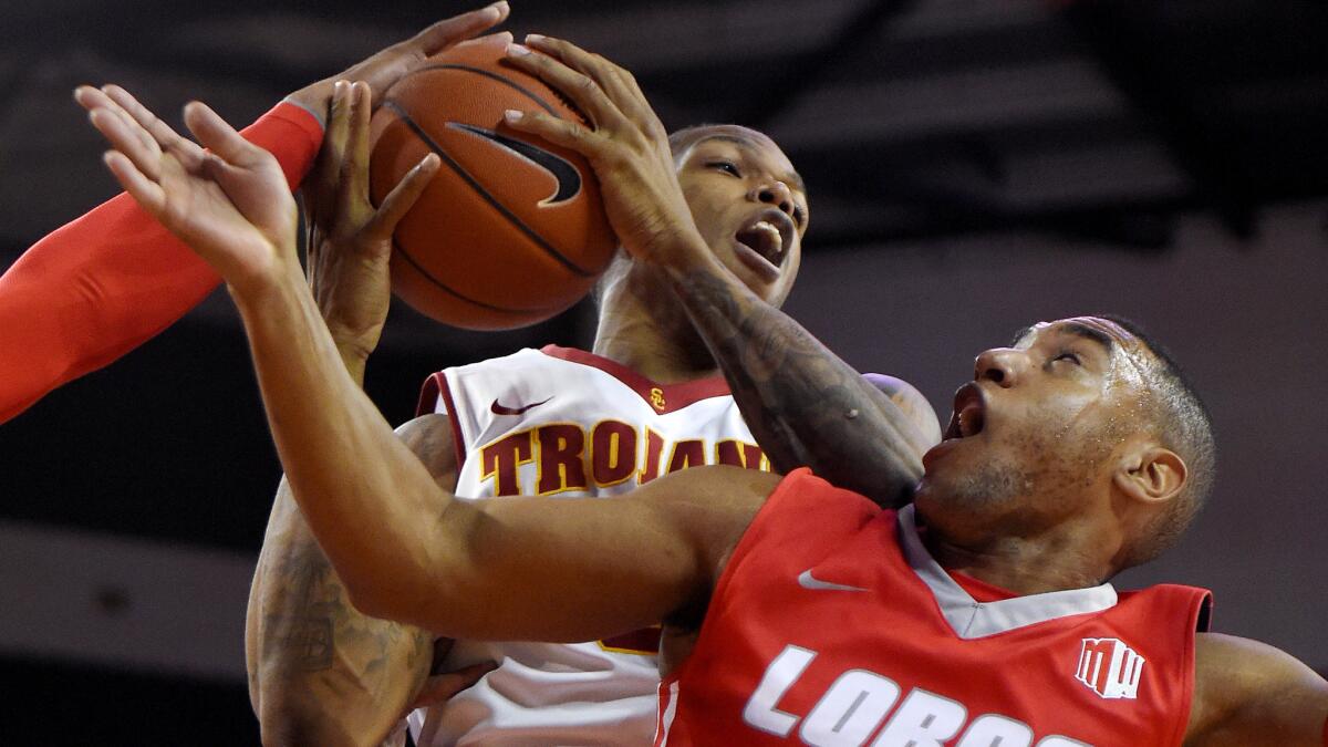 USC forward Darion Clark grabs a rebound away from New Mexico guard Tim Jacobs during the second half of a game Nov. 21.