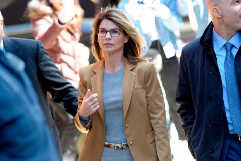(FILES) In this file photo taken on April 03, 2019 Actress Lori Loughlin (C) arrives at the court to appear before Judge M. Page Kelley to face charge for allegedly conspiring to commit mail fraud and other charges in the college admissions scandal at the John Joseph Moakley United States Courthouse in Boston, Massachusetts. - American actress Lori Loughlin and her husband, accused of paying a $500,000 bribe to secure their daughters' entry into a prestigious California university, on April 15, 2019, pleaded not guilty to money laundering charges. The couple waived their right to appear before a judge to be formally accused and entered their pleas through documents filed by their attorneys, according to documents seen by AFP. (Photo by Joseph Prezioso / AFP)JOSEPH PREZIOSO/AFP/Getty Images ** OUTS - ELSENT, FPG, CM - OUTS * NM, PH, VA if sourced by CT, LA or MoD **