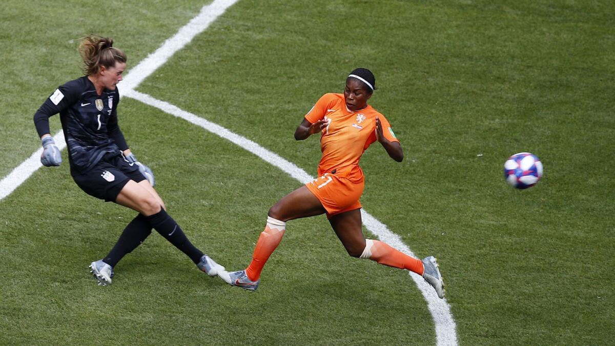 U.S. goalkeeper Alyssa Naeher, left, runs out of the goal box to kick the ball away from Netherlands forward Lineth Beerensteyn during the first half of the Women's World Cup final in Lyon, France, on Sunday.