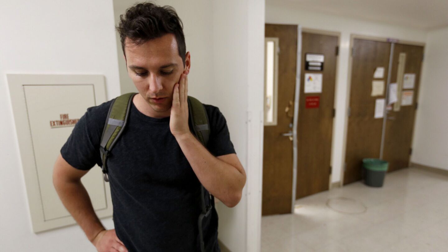 Charles Kawczynski, a doctoral mechanical engineering student, talks on June 2 about the shooting at UCLA as he stands in front of damaged doors on the fourth floor of the Engineering Building, where the slaying of a professor occurred.