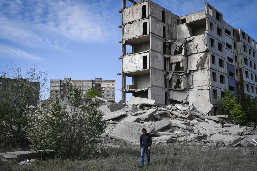 A local resident walks next to a house destroyed in a Russian shelling in Kramatorsk, Ukraine, Wednesday, May 25, 2022. (AP Photo/Andriy Andriyenko)