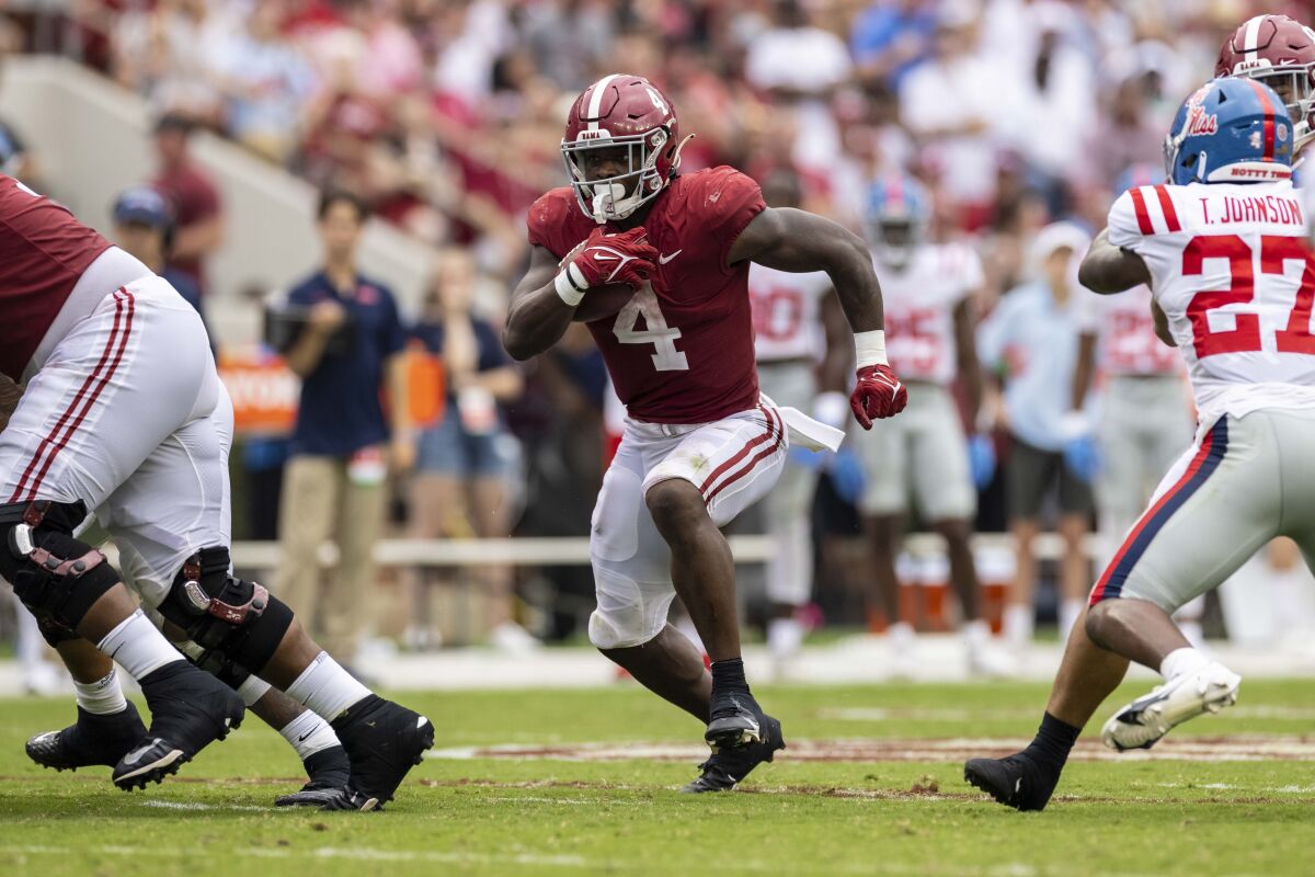 Alabama running back Brian Robinson Jr. (4) runs through an open hole against Mississippi during the second half of an NCAA college football game, Saturday, Oct. 2, 2021, in Tuscaloosa, Ala. (AP Photo/Vasha Hunt)