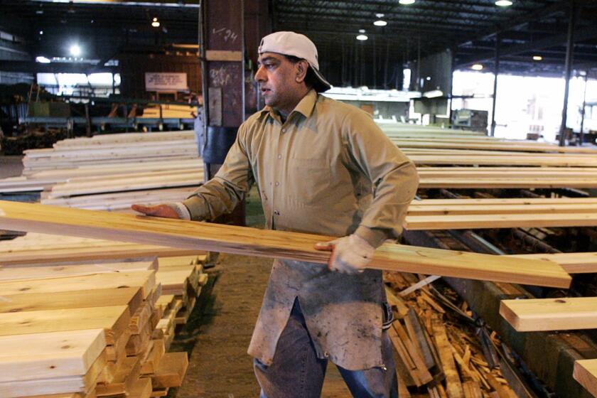 A worker sorts and stacks lumber at the PanAbode Mill in Richmond, B.C., Thursday, April 27, 2006. The Bush administration announced Thursday that it had reached a tentative agreement with Canada to settle a trade battle over softwood lumber. The United States has been imposing penalty duties on Canadian lumber for a number of years, contending that Canada is unfairly subsidizing its own producers. (AP Photo/CP, Chuck Stoody)