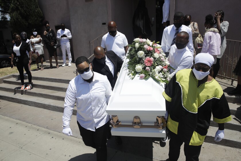 Pall bearers carry a casket with the body of Lydia Nunez, who died from COVID-19.