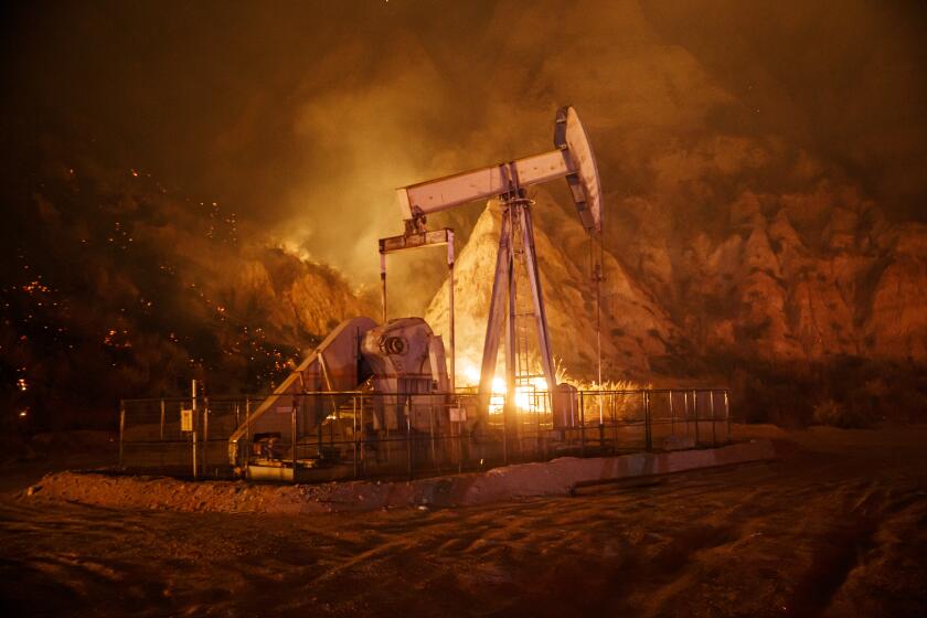 SANTA PAULA, CALIF. -- FRIDAY, NOVEMBER 1, 2019: An oil rig sits unharmed as the Maria Fire moves towards in Santa Paula, Calif., on Nov. 1, 2019. (Marcus Yam / Los Angeles Times)