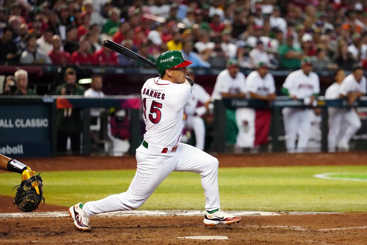 Mexico's Austin Barnes doubles during the ninth inning against Colombia. 