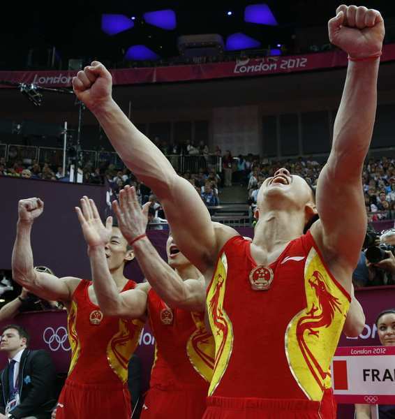 China's team celebrates at the men's team final of the artistic gymnastics.