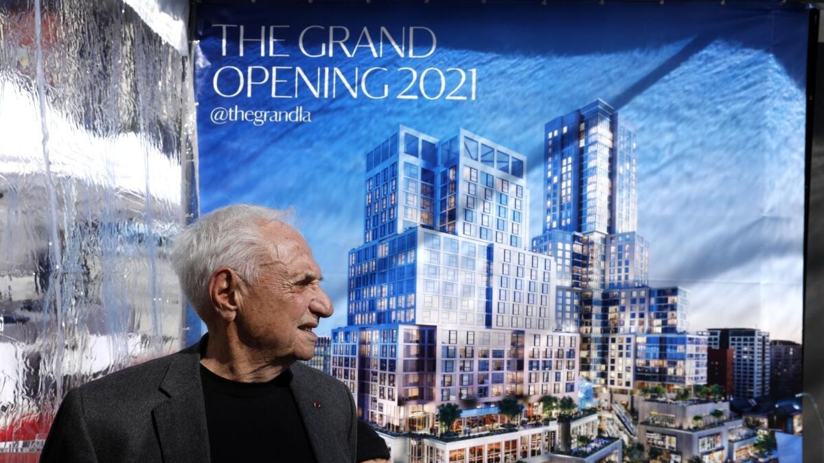 Architect Frank Gehry stands in front of a banner featuring a rendering of the Grand during a groundbreaking ceremony for the new development in downtown Los Angeles on Monday. The $1-billion complex will house condos, shops, restaurants and a hotel.