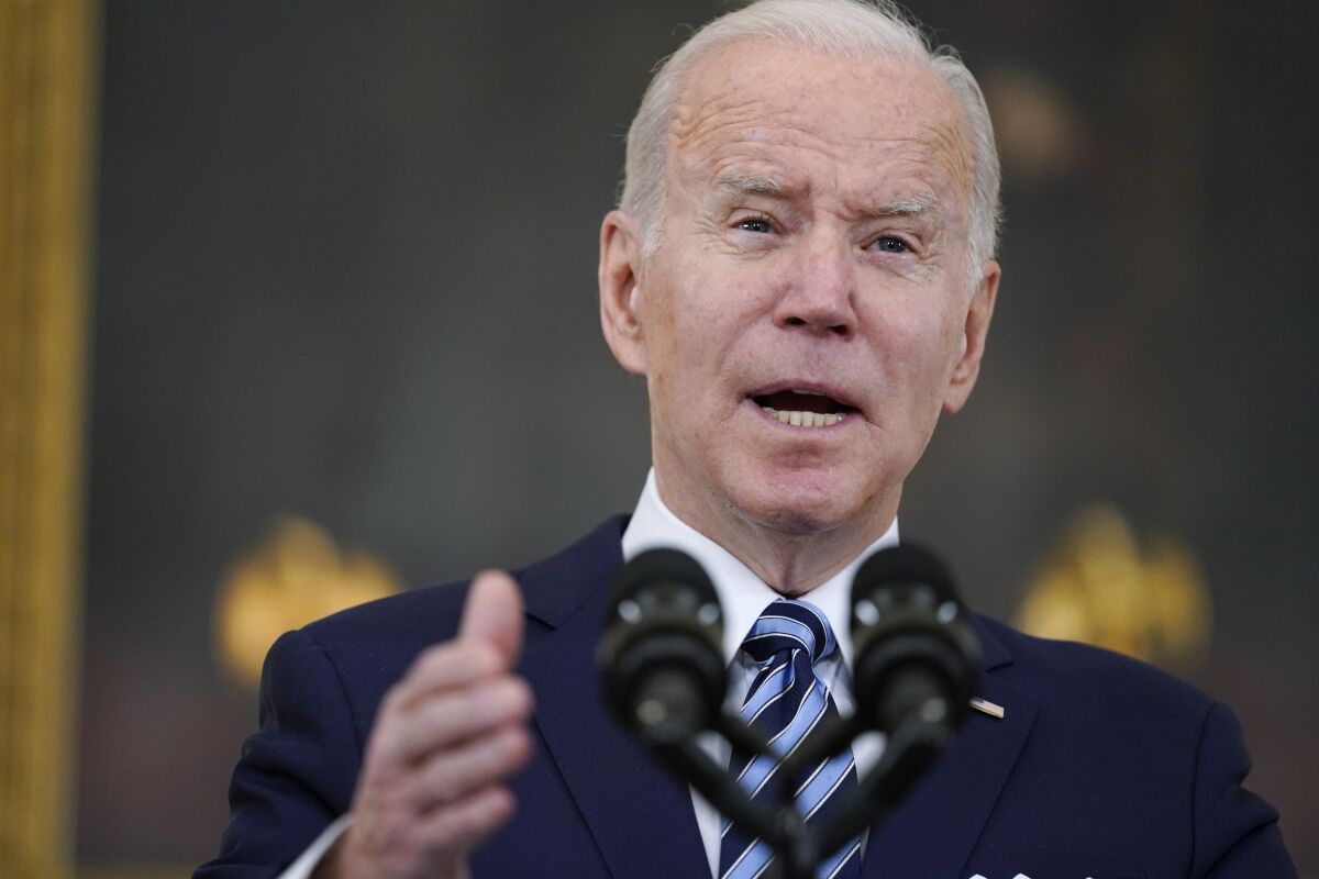 President Biden speaks into microphones