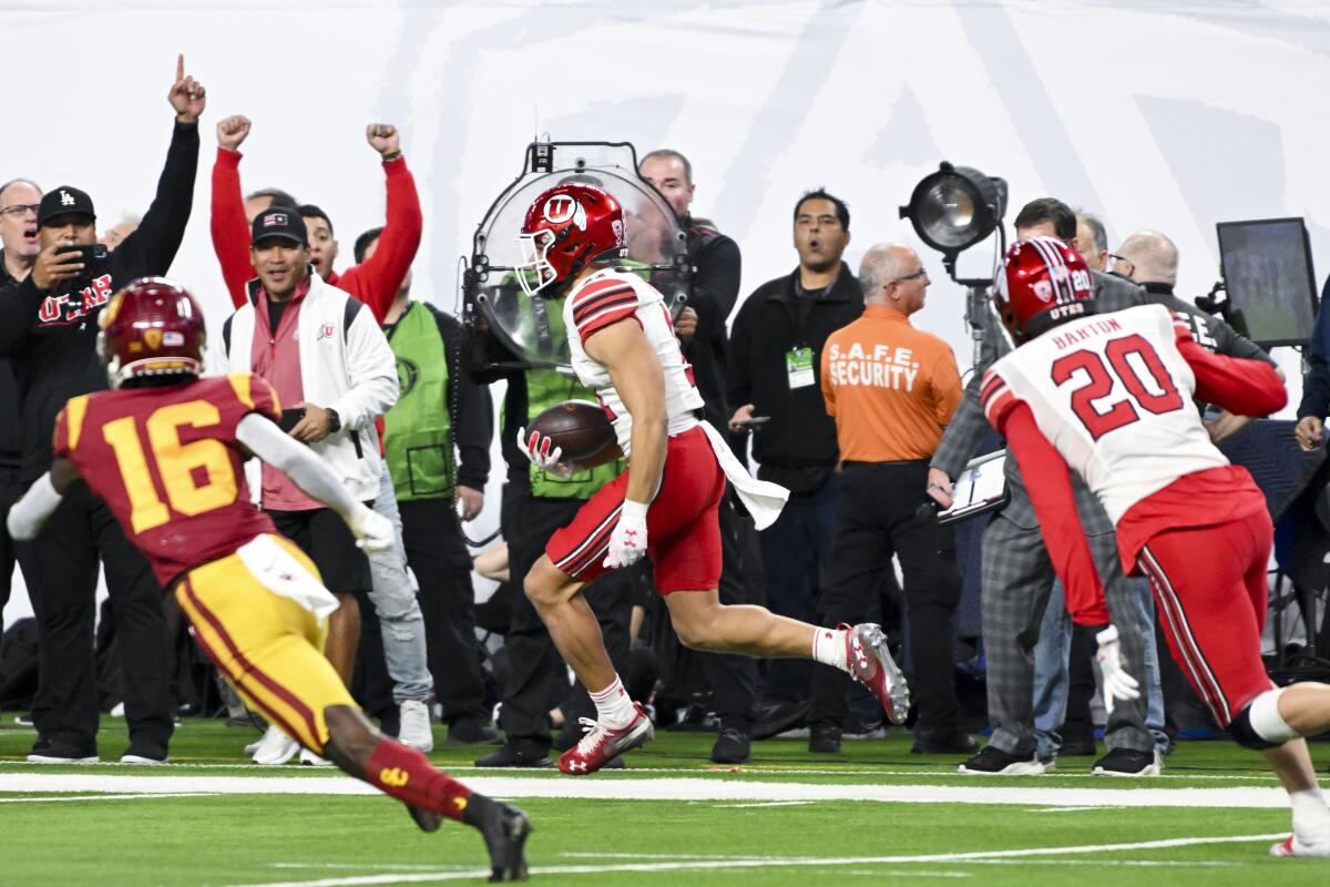 Utah safety R.J. Hubert runs back the ball after intercepting a ball thrown by USC quarterback Caleb Williams 