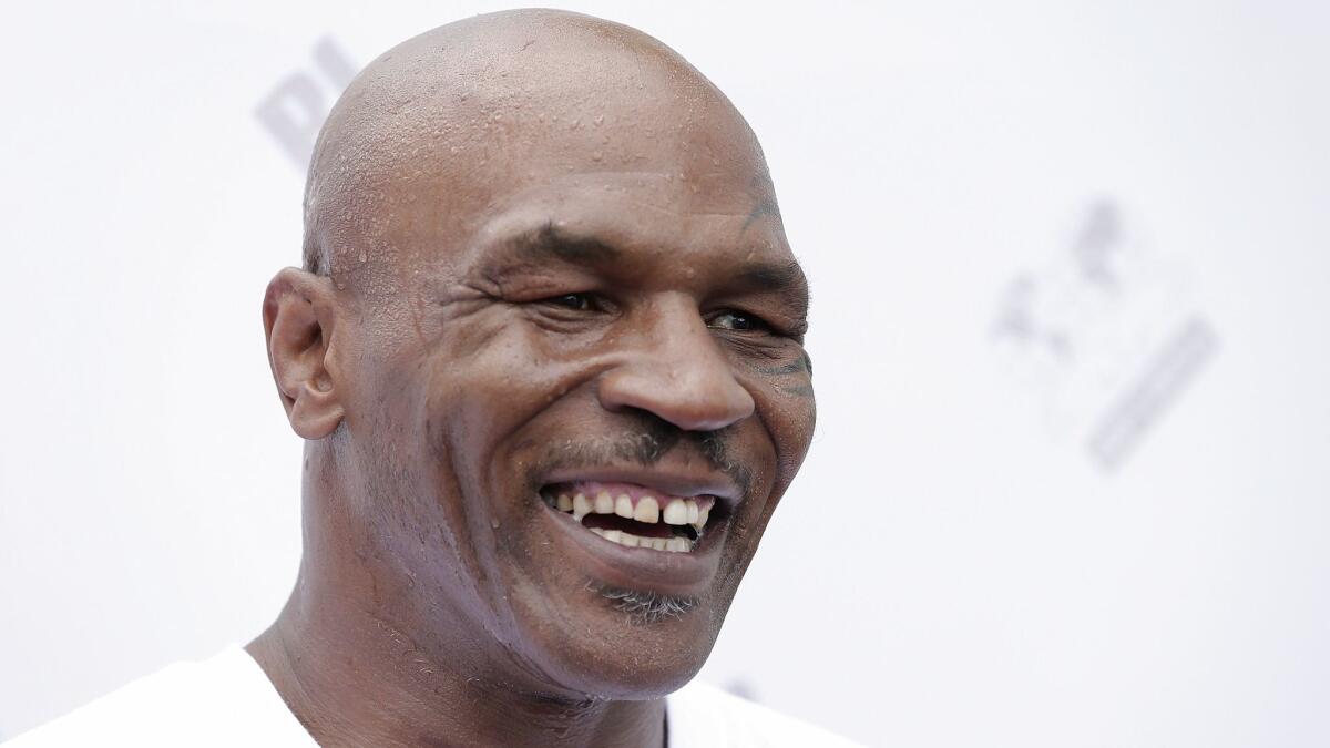 Former heavyweight champion boxer Mike Tyson, shown hear last year at a boxing event in China, will bring a new version of his "Undisputed Truth" one-man show to Las Vegas starting in September.