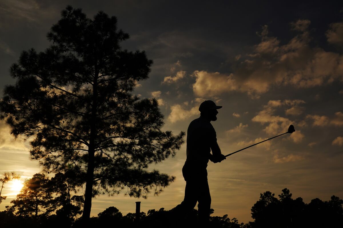 Dustin Johnson hits a shot on the 18th hole during the third round of the Masters on Saturday.