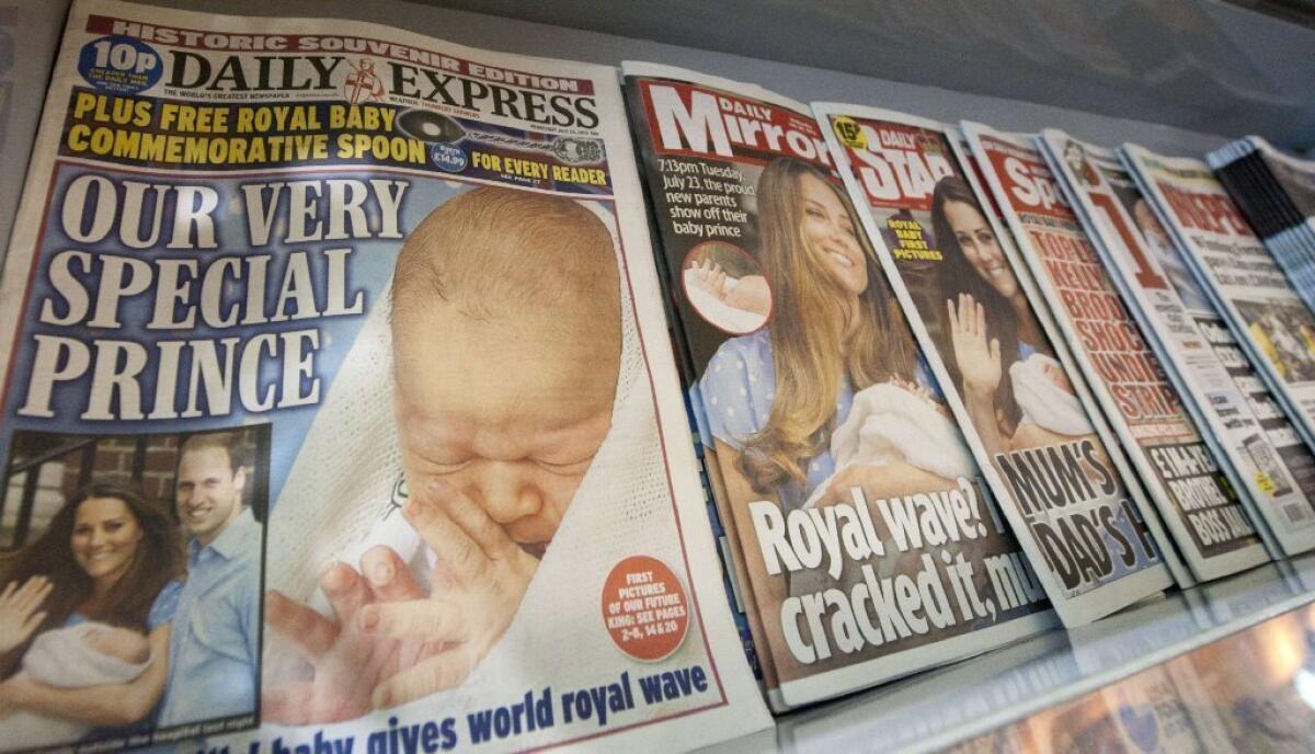 A news stand displays a selection of British newspapers showing the new royal baby in central London, on July 24.
