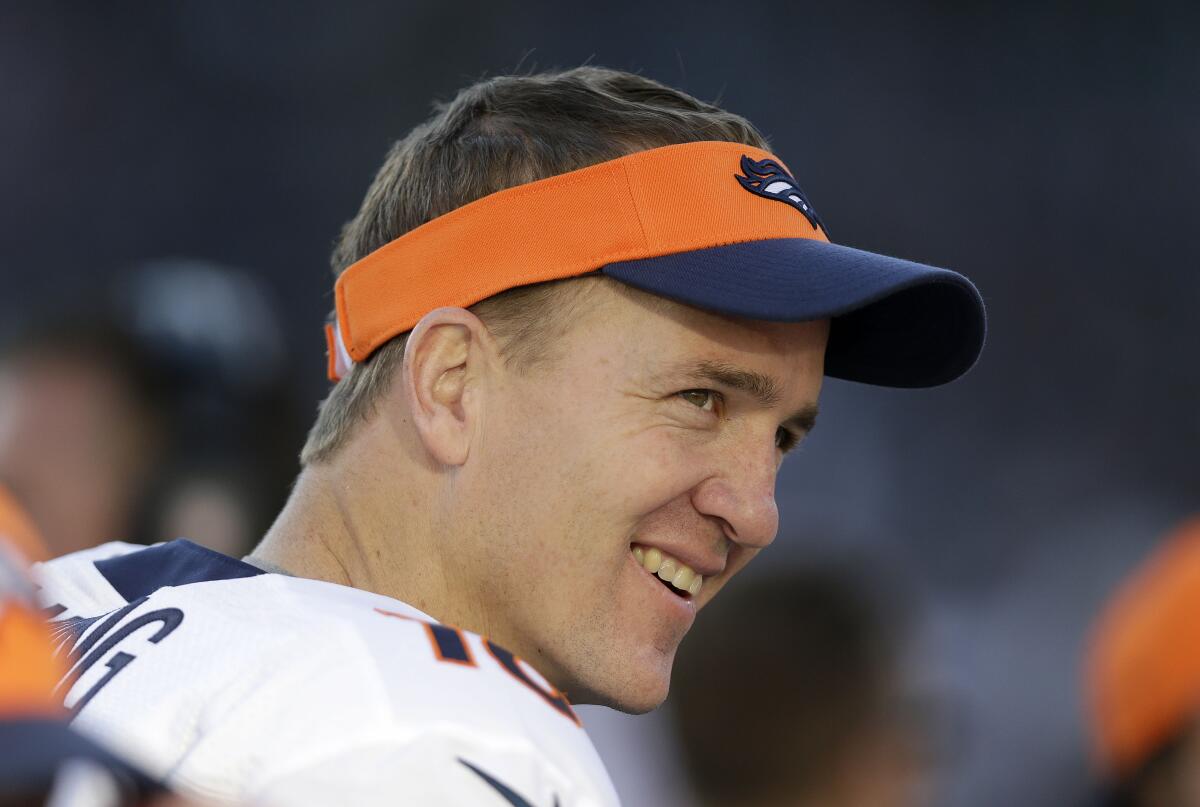 Denver Broncos quarterback Peyton Manning smiles on the sidelines.