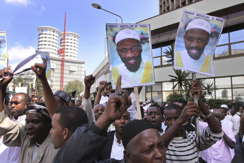 FILE - Placards showing Sheik Abdullah el-Faisal are held up by demonstrators in Nairobi, Kenya, Jan. 15, 2010, protesting the arrest of the radical Jamaican-born Muslim cleric who was jailed because Kenyan authorities said he was a threat to the security of their country. El-Faisal who was accused of recruiting support for the Islamic State group and was extradited to New York City after an undercover New York Police Department sting that went international, was convicted on Thursday, Jan. 26, 2023, of state terrorism charges. (AP Photo/Khalil Senosi, File)