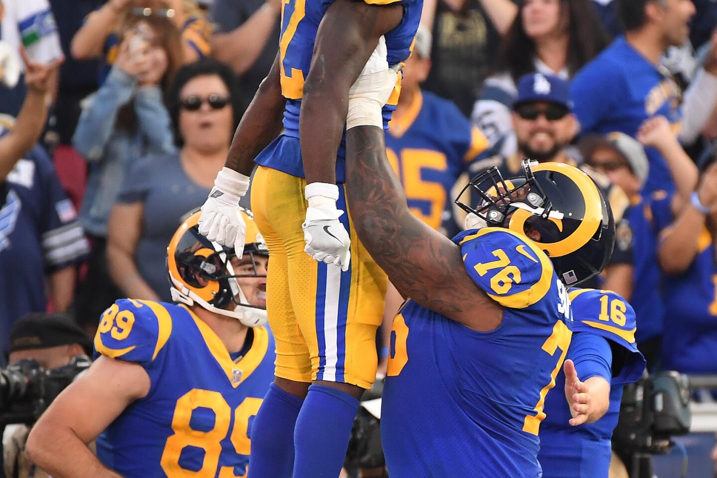 Rams receiver Brandin Cooks is lifted into the air by Rodger Saffold after scoring a touchdown against the Seahawks in the fourth quarter at the Coliseum on Sunday.