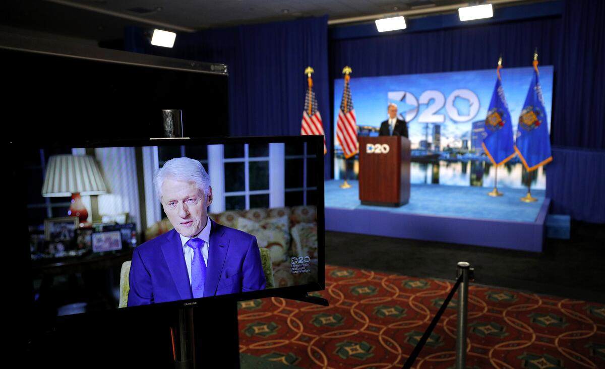 President Clinton delivers a speech by video feed as Democratic National Committee Chairman Tom Perez watches