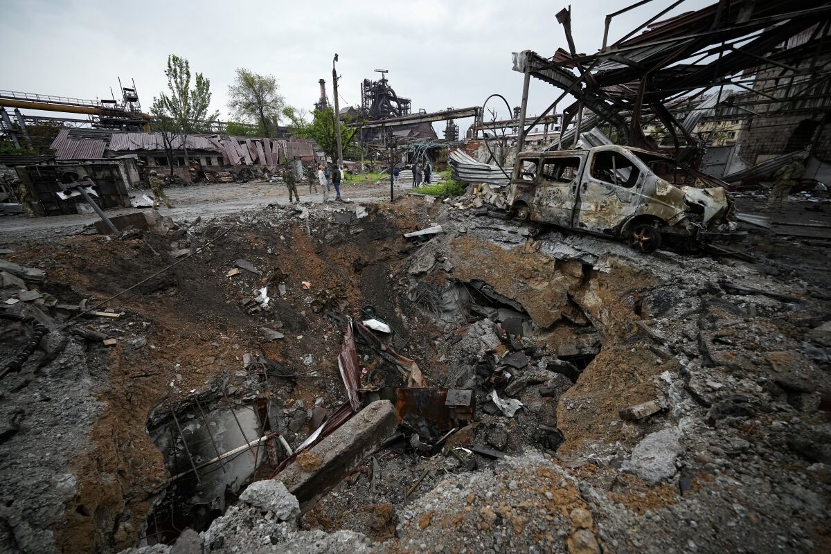 An international group of journalists visit a destroyed part of the Illich Iron & Steel Works Metallurgical Plant in Mariupol, in territory under the government of the Donetsk People's Republic, eastern Ukraine, Wednesday, May 18, 2022. This photo was taken during a trip organized by the Russian Ministry of Defense. (AP Photo)