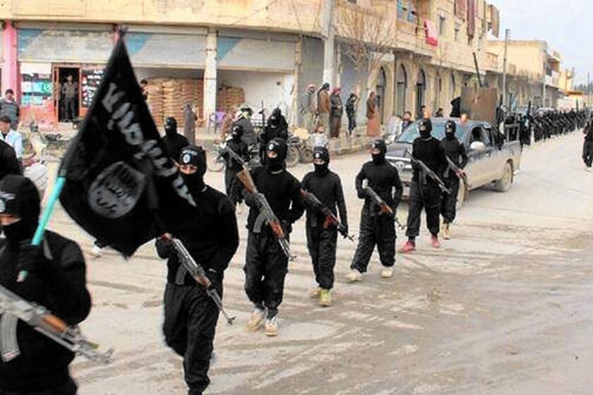 Islamic State fighters march in Raqqah, Syria, in an undated image.